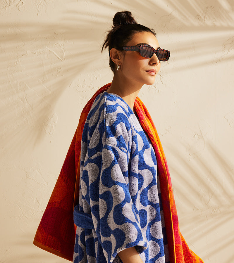 Women wearing wave robe drying her hair with a wave length print towel