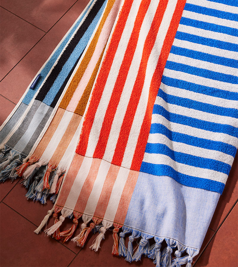 Close up image of the multicolor stiped blanket. 