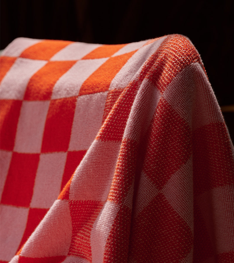 Detailed shot of the checkerboard towel, looking plush and draping luxuriously.