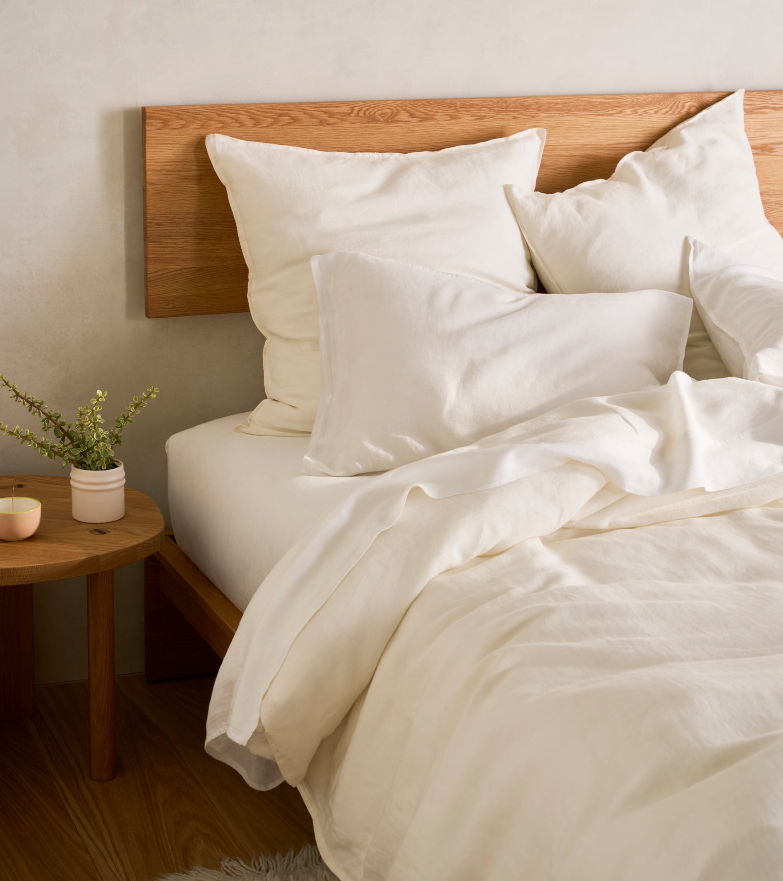 a bed with cream sheets