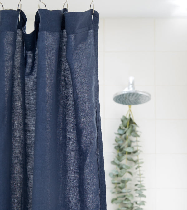 White bathroom with navy linen shower curtain